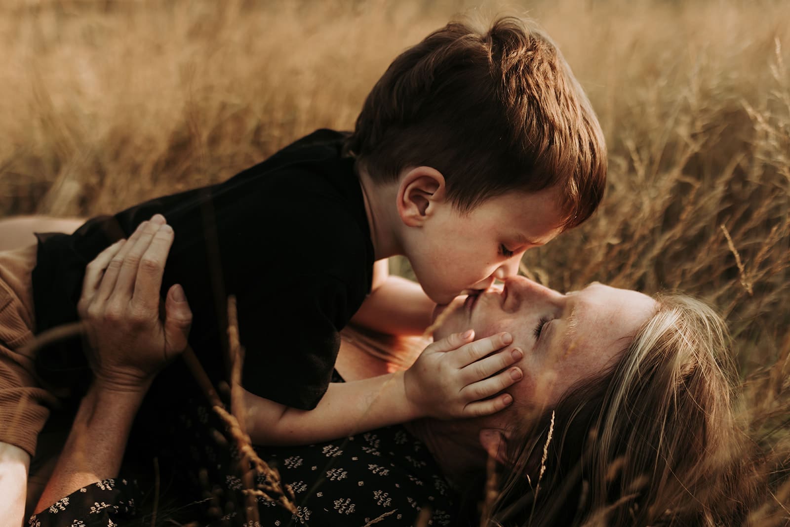 Son kissing Mom during U picking during the summer on Vancouver Island