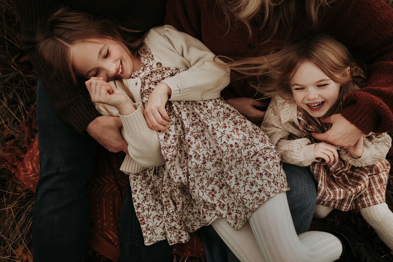 Two daughters laughing while being tickled by their mom and dad in Victoria, bc