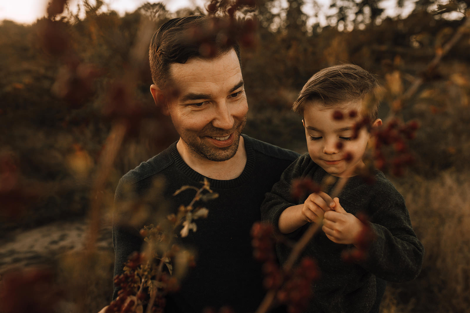 son and dad picking sunflowers in Victoria, BC