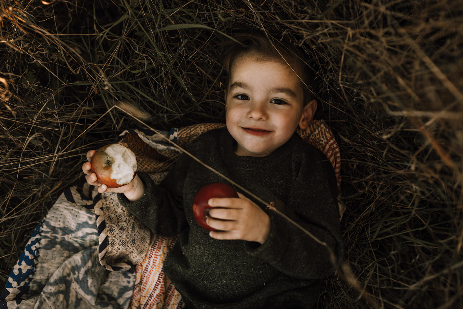 boy eating apples in an orchard in Victoria, BC